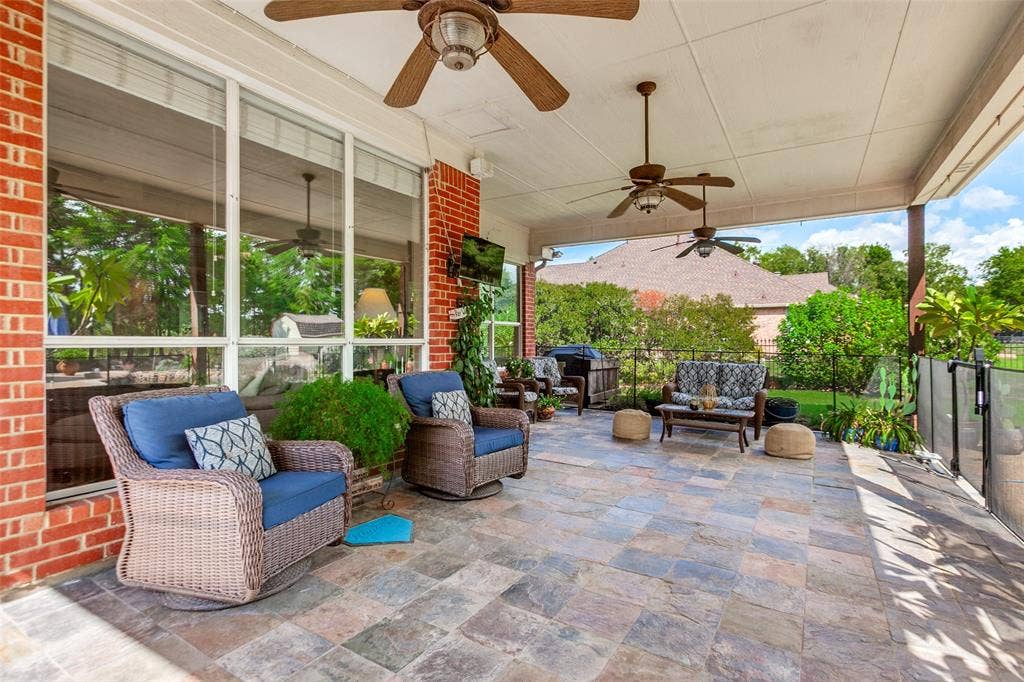 214 Stanford Ct. - Spacious covered back patio with slate flooring, ceiling fans, and views overlooking the pool—perfect for outdoor relaxation and entertaining.