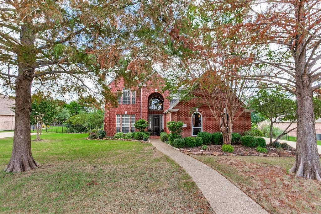 204 Stanford Ct. - Traditional two-story home nestled among mature trees.