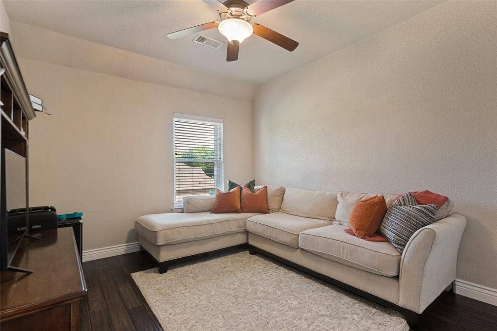 214 Stanford Ct. - Second-floor bedroom featuring hardwood flooring and ceiling fan.