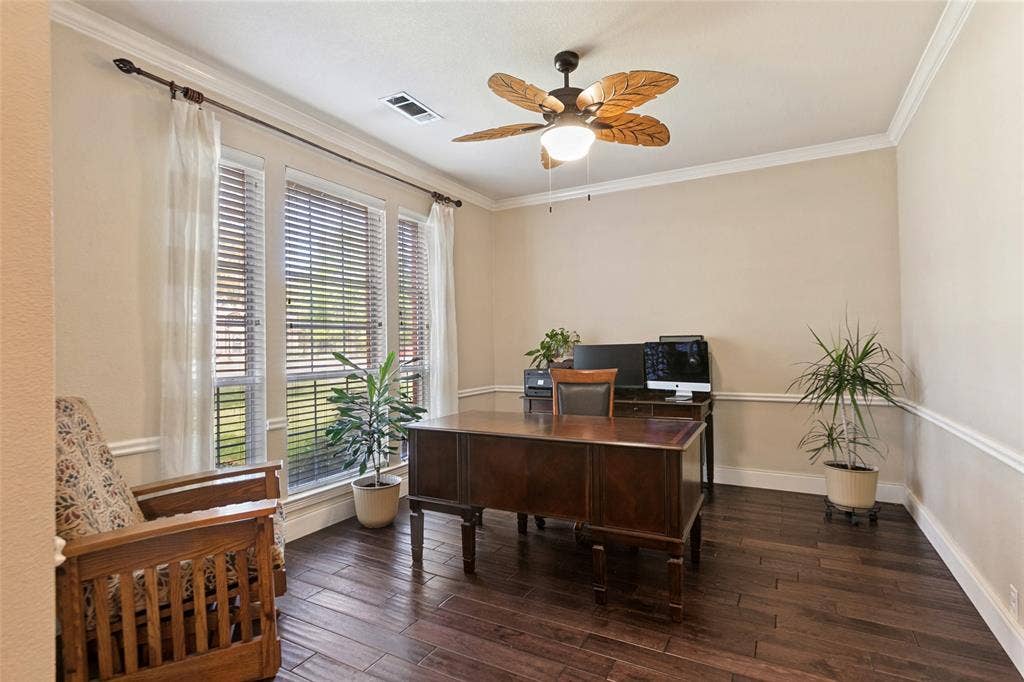 214 Stanford Ct. - Dining room featuring hardwood floors, chair rail, and fresh paint, currently used as a home office.