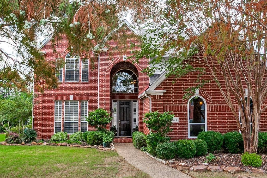 204 Stanford Ct. - Traditional two-story home nestled among mature trees.