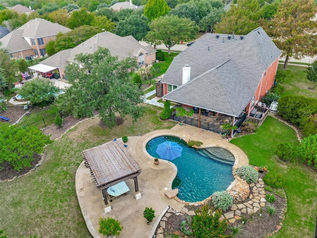 214 Stanford Ct. - Aerial view of the rear of the home showcasing the resort-style pool and lush landscaping.