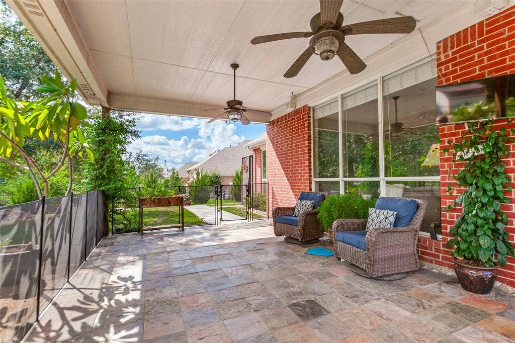 214 Stanford Ct. - Spacious covered back patio with slate flooring, ceiling fans, and views overlooking the pool—perfect for outdoor relaxation and entertaining.