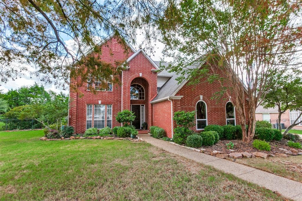 204 Stanford Ct. - Traditional two-story home nestled among mature trees.