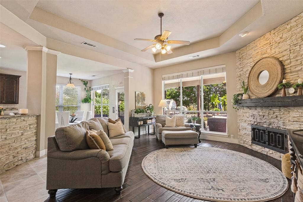214 Stanford Ct. - Living room with expansive windows overlooking the patio and pool, flowing seamlessly into the breakfast area.