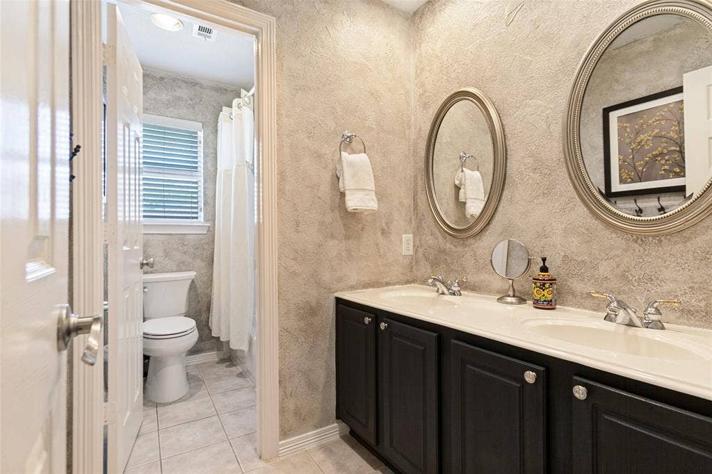 214 Stanford Ct. - Second-floor bathroom featuring a spacious dual-sink vanity and tub-shower combination.
