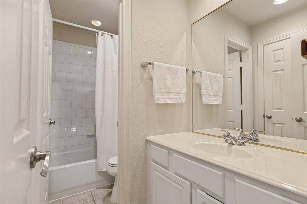214 Stanford Ct. - Second-floor bathroom featuring a spacious vanity and tub-shower combination.