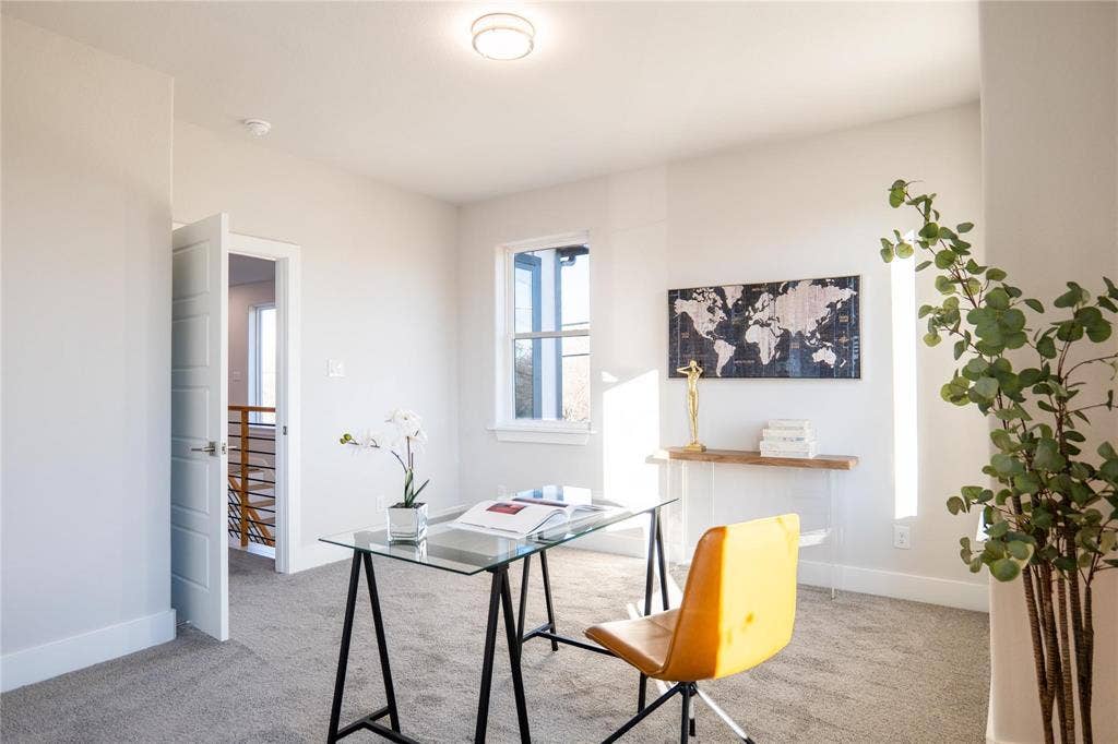 Neutral-toned interior space featuring neutral carpeting, a single-hung window, and a white interior door