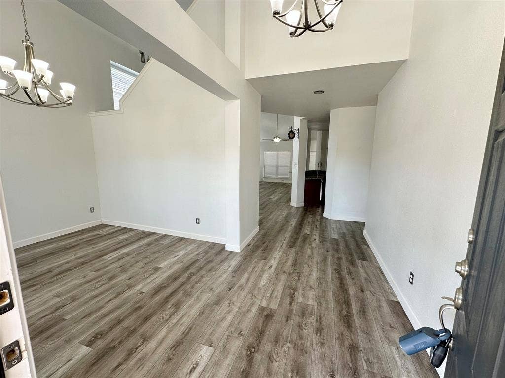 9756 Old Field Drive, McKinney, TX 75072 Vaulted ceilings, wood-finish flooring, and multi-arm chandelier lighting