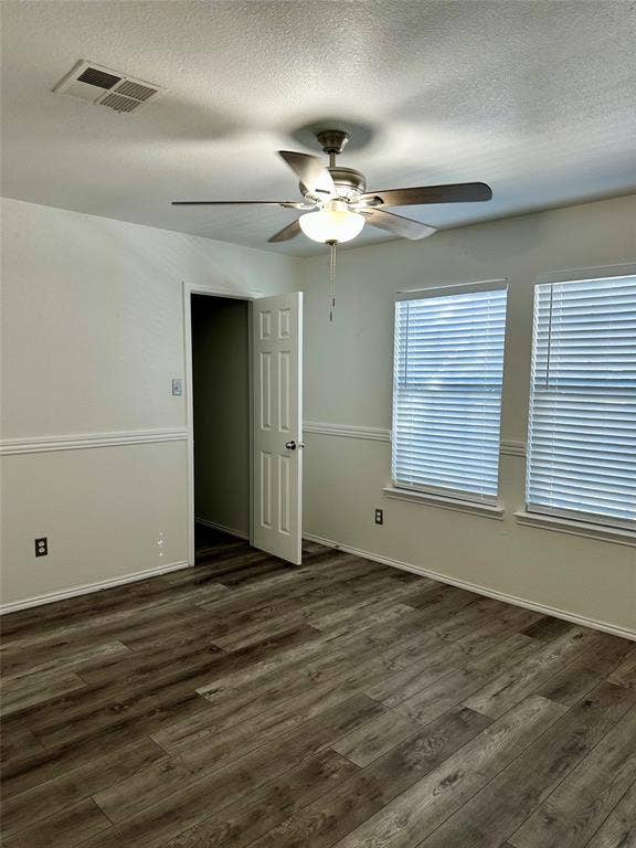 9756 Old Field Drive, McKinney, TX 75072 Interior room featuring wood-finish flooring, chair rail molding, dual windows with integrated blinds, and a brushed metal ceiling fan with light fixture