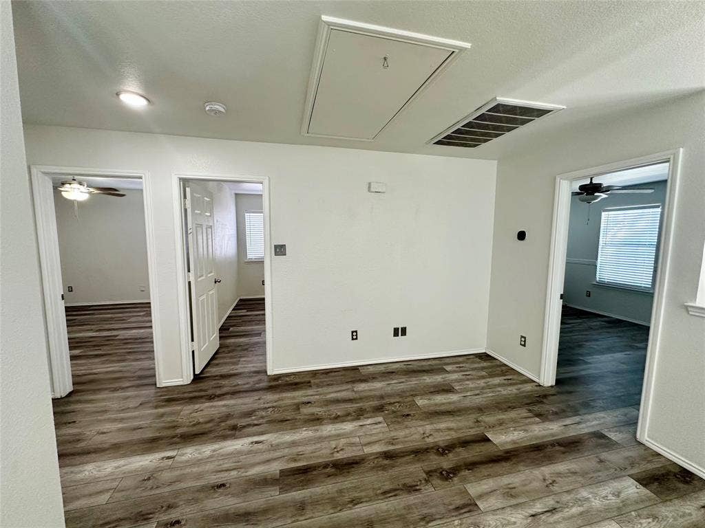 9756 Old Field Drive, McKinney, TX 75072 Interior space featuring wood-finish flooring, ceiling-mounted light fixtures, and multi-panel interior doors