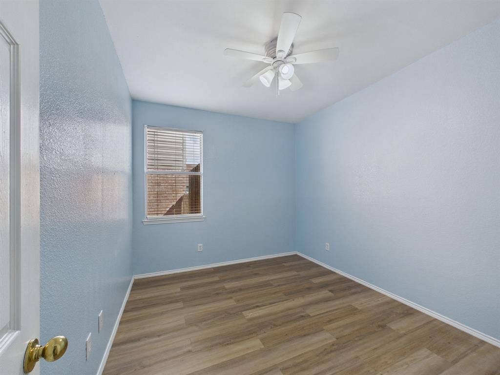 12652 Oakwood Circle, Fort Worth, TX 76040 Room featuring wood-finish flooring, a single window, and a ceiling-mounted light fixture with a fan