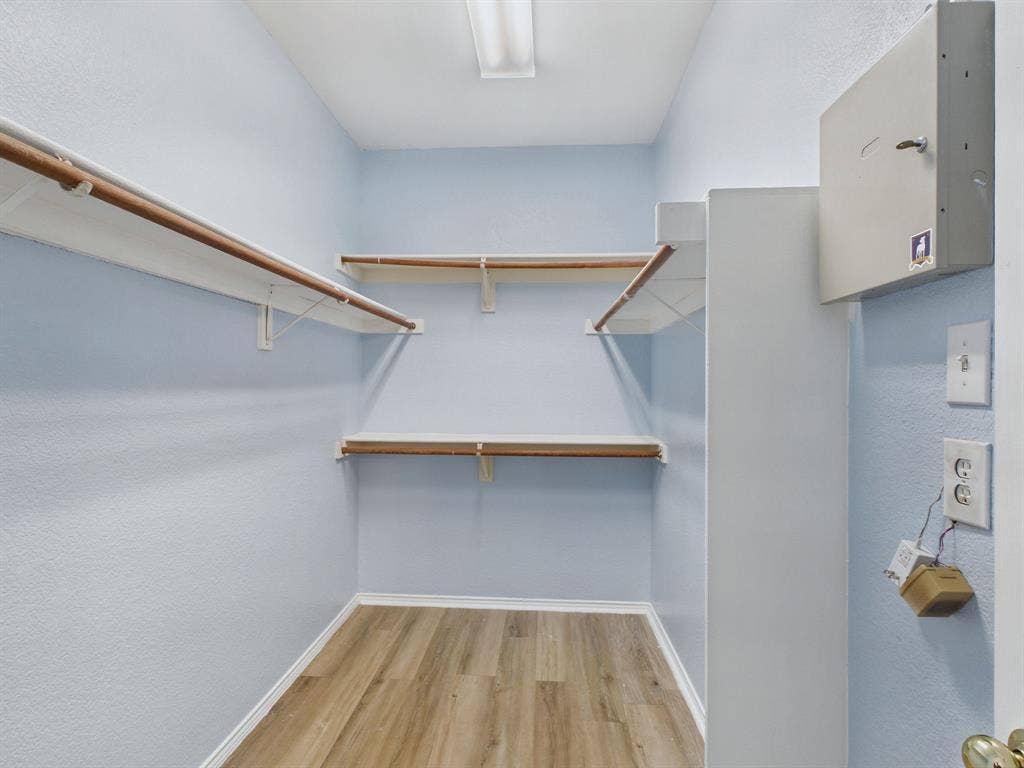 12652 Oakwood Circle, Fort Worth, TX 76040 Storage space featuring wood-finish flooring, multi-level shelving, and overhead lighting