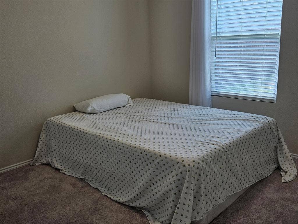 1860 Ballinger Drive, Forney, TX 75126 Neutral-toned wall paint, plush carpeting, and a window fitted with horizontal blinds