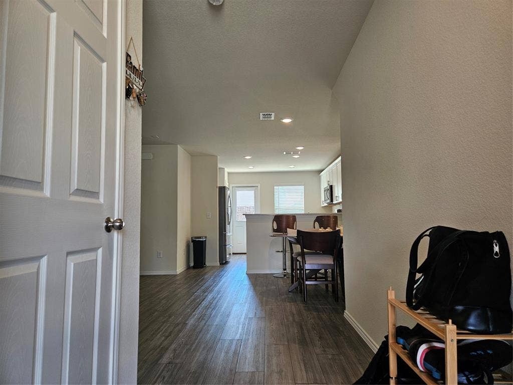 1860 Ballinger Drive, Forney, TX 75126 Interior featuring wood-finish flooring, recessed lighting, and a kitchen peninsula with a raised breakfast bar