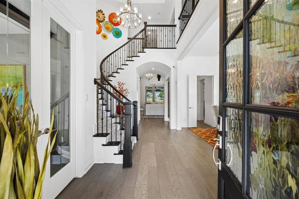 641 Country Brook Lane, Prosper, TX 75078 Stunning wood floor entry with winding staircase. Entry is flanked by elegantly designed study and formal dining room.