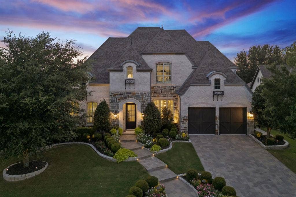 641 Country Brook Lane, Prosper, TX 75078 Evening view does not do it justice because its not dark enough yet. This home really stands out at night with lights shining up trees and lights illuminating the home.
