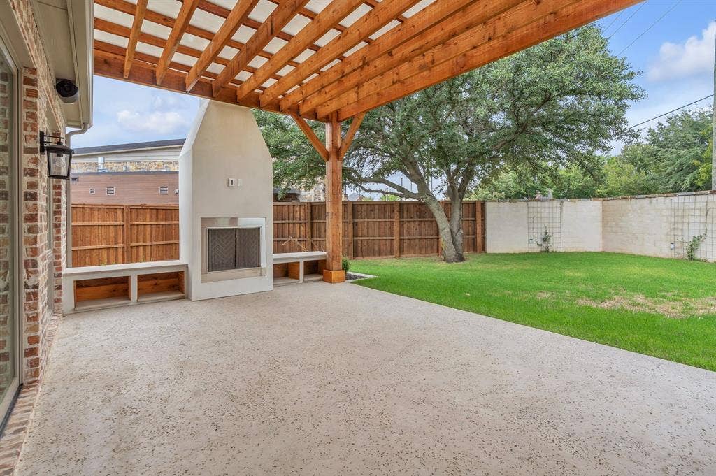 20 X 14 covered patio with gas fireplace and masonry back fence