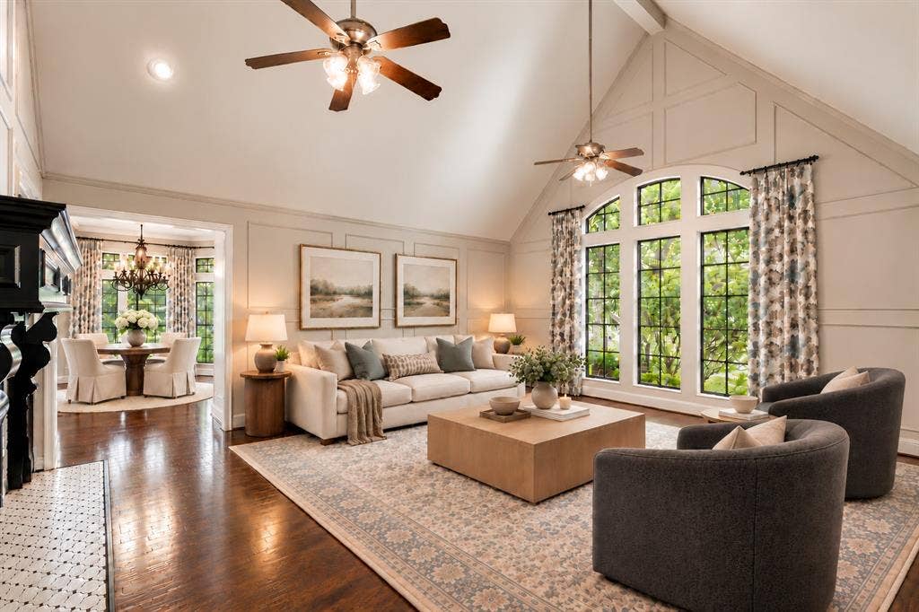 Vaulted ceilings, paneled walls, wood-finish flooring, and arched floor-to-ceiling windows featuring grid muntins
