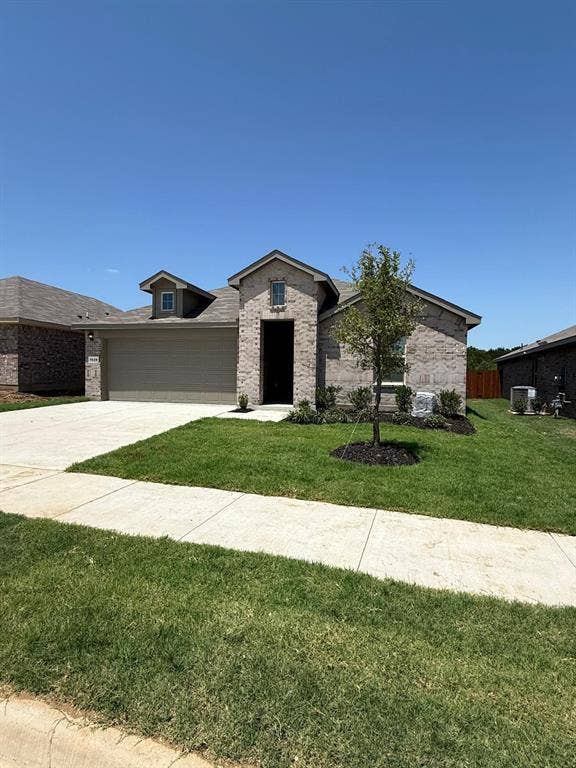 Single-story brick exterior featuring a multi-gabled roofline, an attached two-car garage, and a covered entryway
