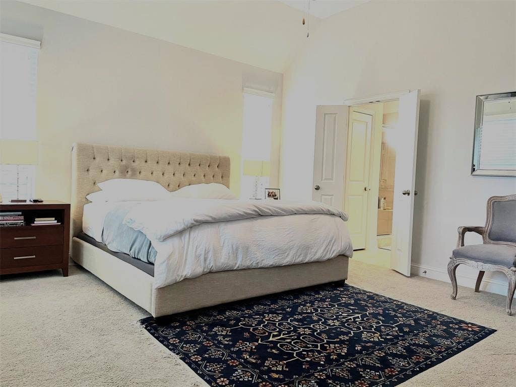 High vaulted ceilings, wall-to-wall carpeting, and double-entry doors