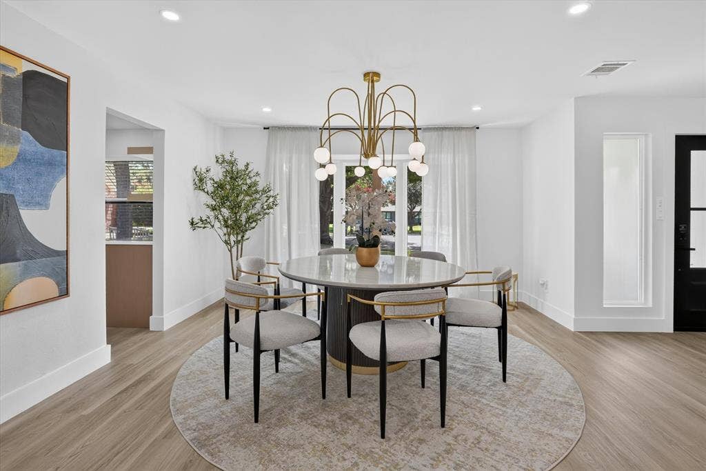 Dining area featuring wood-finish flooring, recessed lighting, and a multi-arm modern brass chandelier