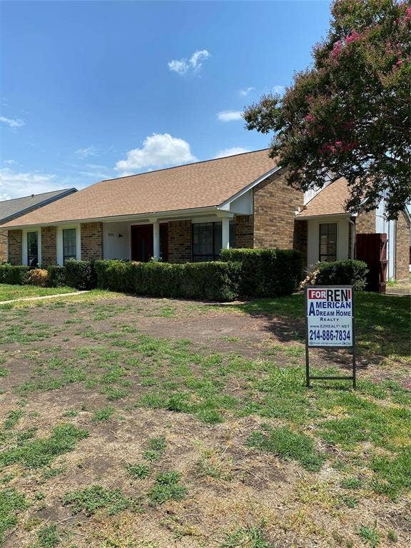 902 Maydelle Lane, Garland, TX 75042 Single-story brick exterior featuring a hip roof, covered porch, and mature landscaping