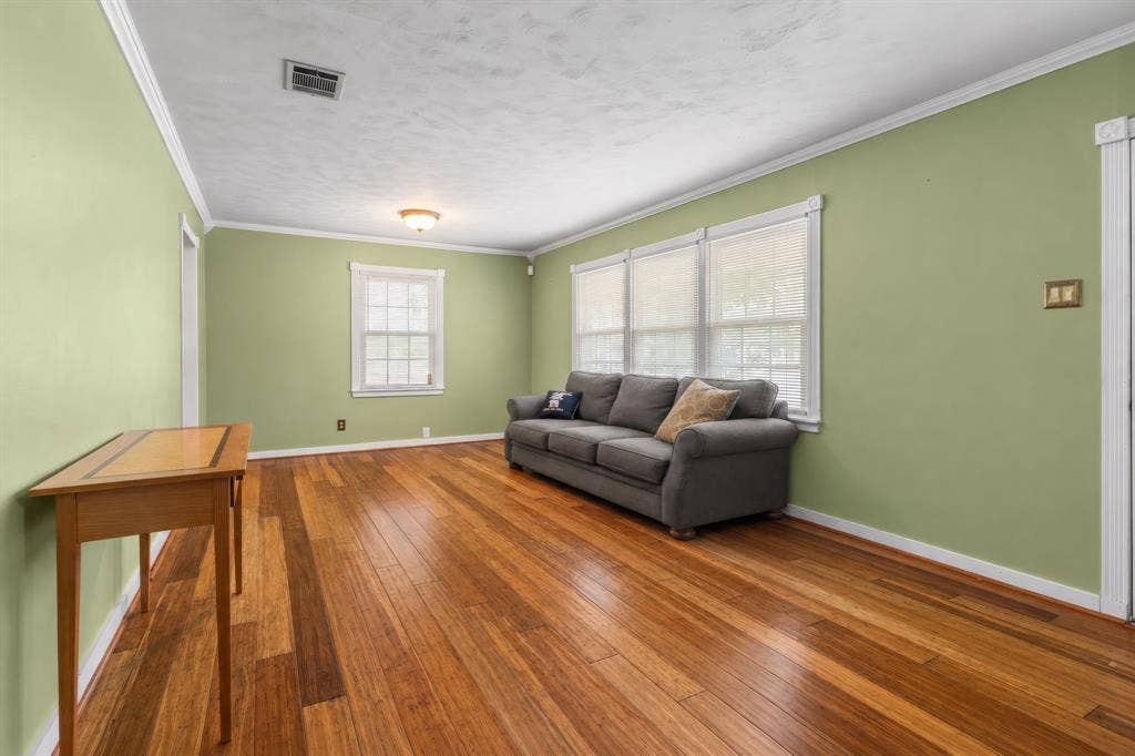 920 Avenue C, Lacy Lakeview, TX 76705 Interior space featuring wood-finish flooring, crown molding, and multiple grid-patterned windows