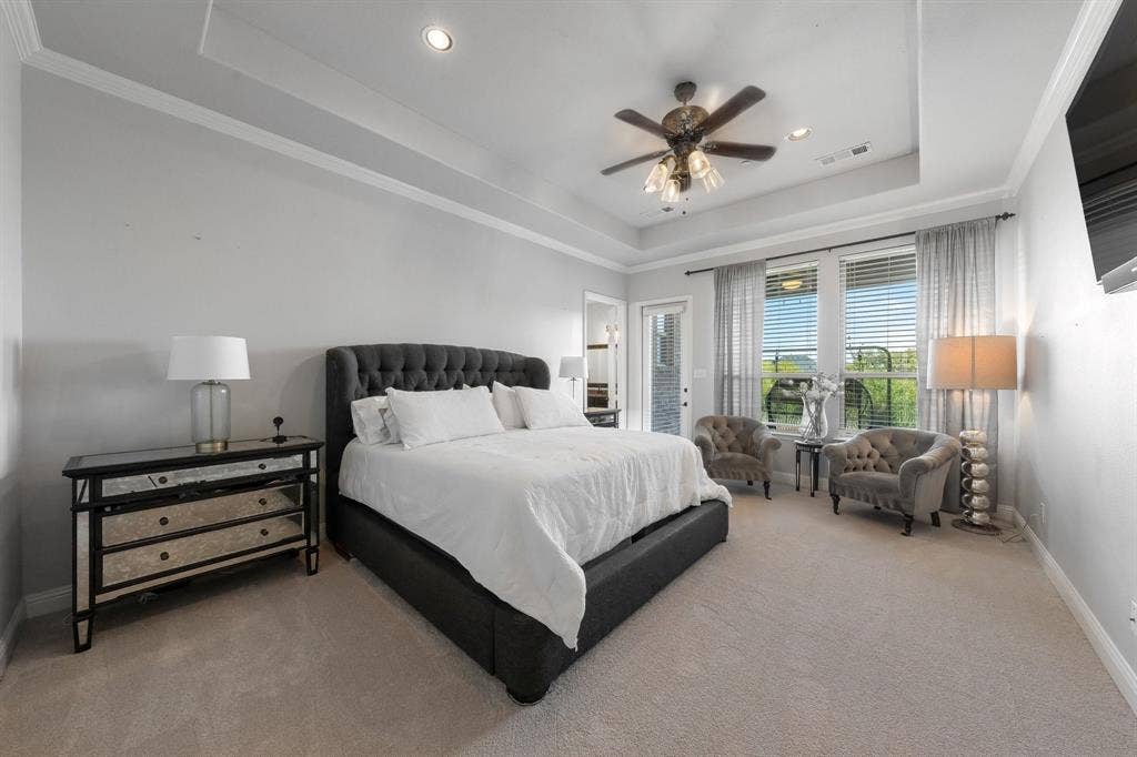Tray ceiling featuring recessed lighting and a central ceiling fan with integrated light fixtures
