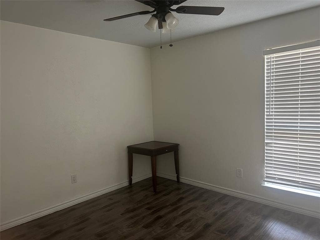 1314 Frio Lane, Garland, TX 75040 Wood-finish flooring, neutral wall tones, multi-light ceiling fan, and horizontal window blinds