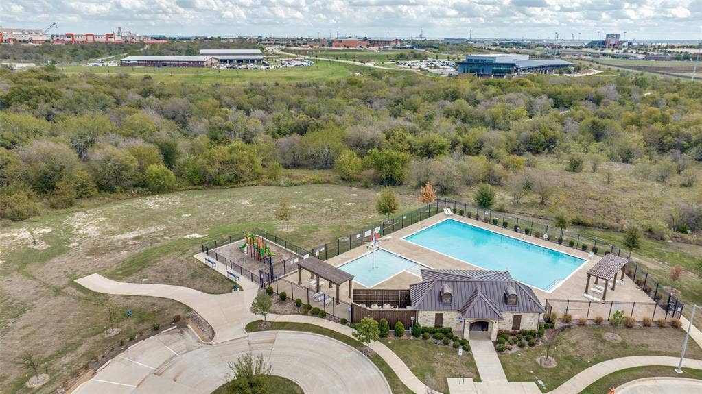 Community amenities featuring a swimming pool, wading pool, fenced playground, and covered pavilion structures