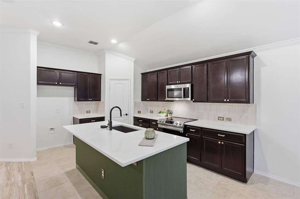 Updates include designer reeded detail and beautiful accent color on Kitchen island