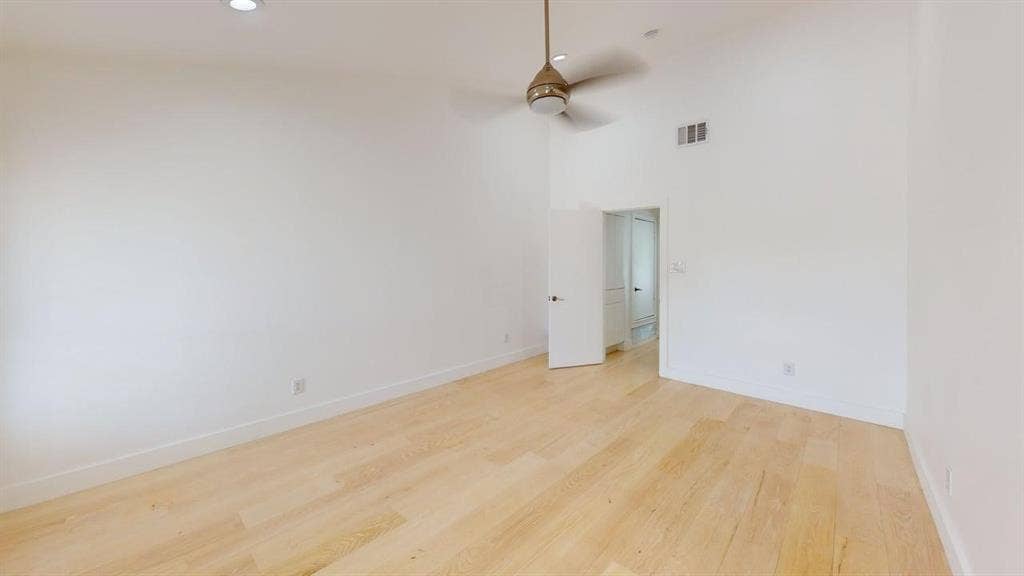 Vaulted ceilings, wood-finish flooring, recessed lighting, and a neutral-tone ceiling fan