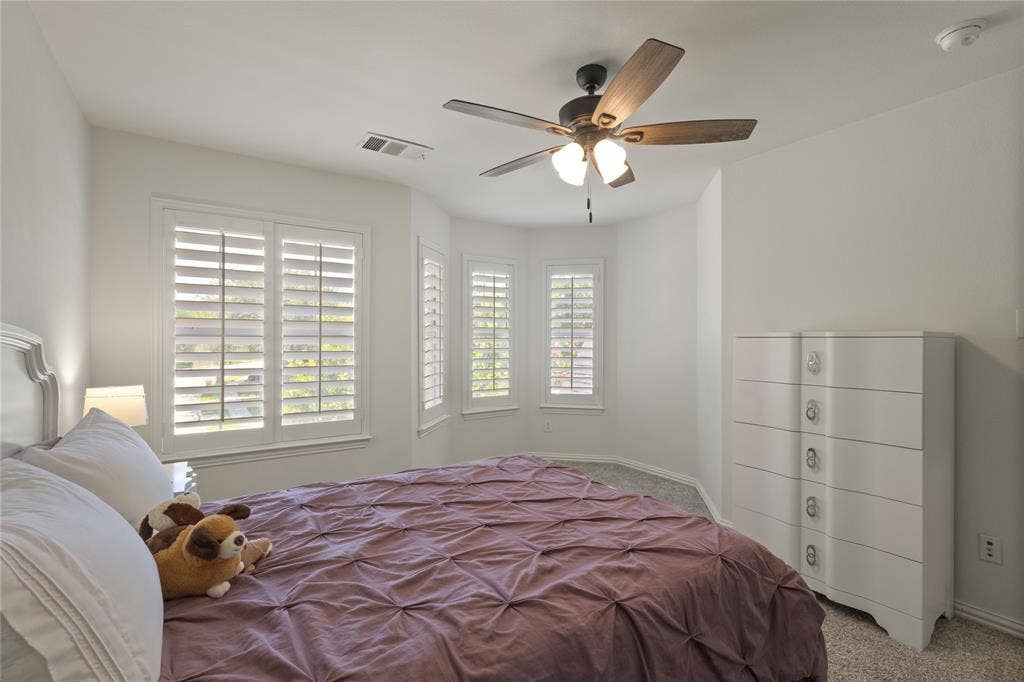 Rounded wall with plantation shutters in upstairs bedroom