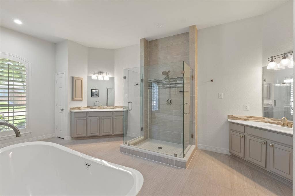 New frameless shower, soaking tub, separate sinks