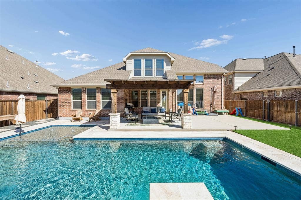 2816 Driftwood Creek Trail, Celina, TX 75078 This backyard has it all. Pool with heater, per friendly turf and a 3 hole putting green!
