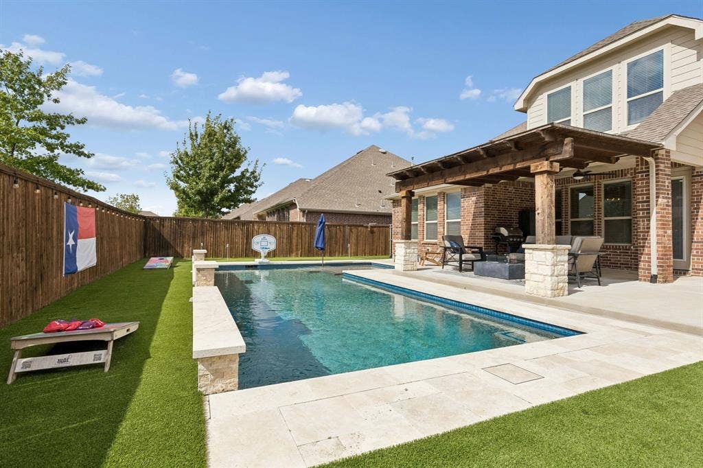2816 Driftwood Creek Trail, Celina, TX 75078 This backyard has it all. Pool with heater, per friendly turf and a 3 hole putting green!