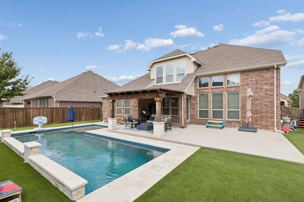 2816 Driftwood Creek Trail, Celina, TX 75078 This backyard has it all. Pool with heater, per friendly turf and a 3 hole putting green!