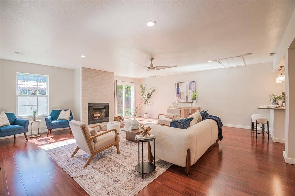 8050 Fall River Drive, Dallas, TX 75228 Living area featuring wood-finish flooring, a floor-to-ceiling masonry fireplace, recessed lighting, a ceiling fan, and glass sliding doors