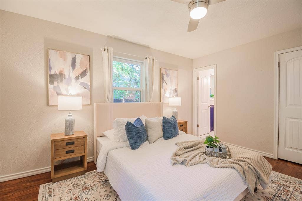 8050 Fall River Drive, Dallas, TX 75228 Neutral-toned walls, wood-finish flooring, ceiling fan with integrated lighting, and multi-panel interior doors