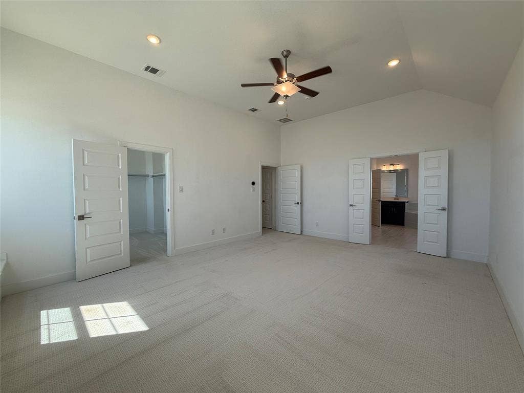 9223 Easy Street, Rowlett, TX 75088 Vaulted ceilings with recessed lighting, neutral carpeting, and a central ceiling fan