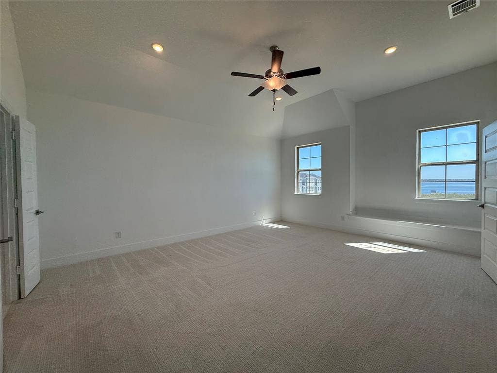 9223 Easy Street, Rowlett, TX 75088 Vaulted ceilings, neutral carpeting, recessed lighting, ceiling fan, and built-in window seating