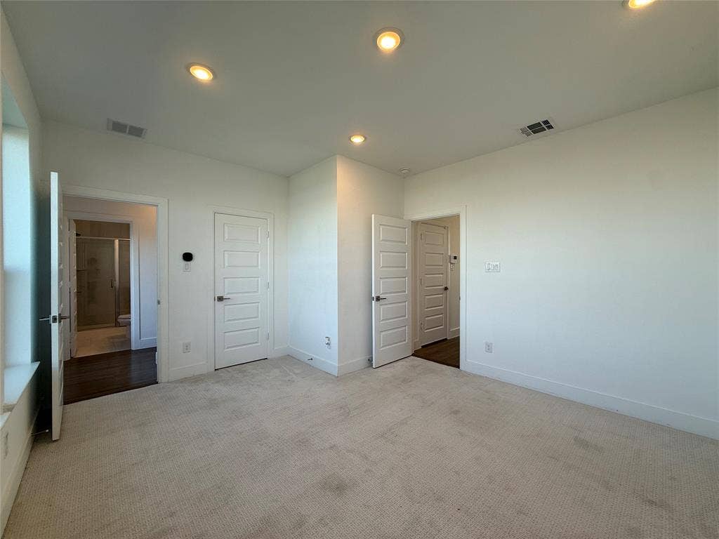 9223 Easy Street, Rowlett, TX 75088 Neutral-toned wall-to-wall carpeting, recessed ceiling lighting, and solid-core paneled interior doors