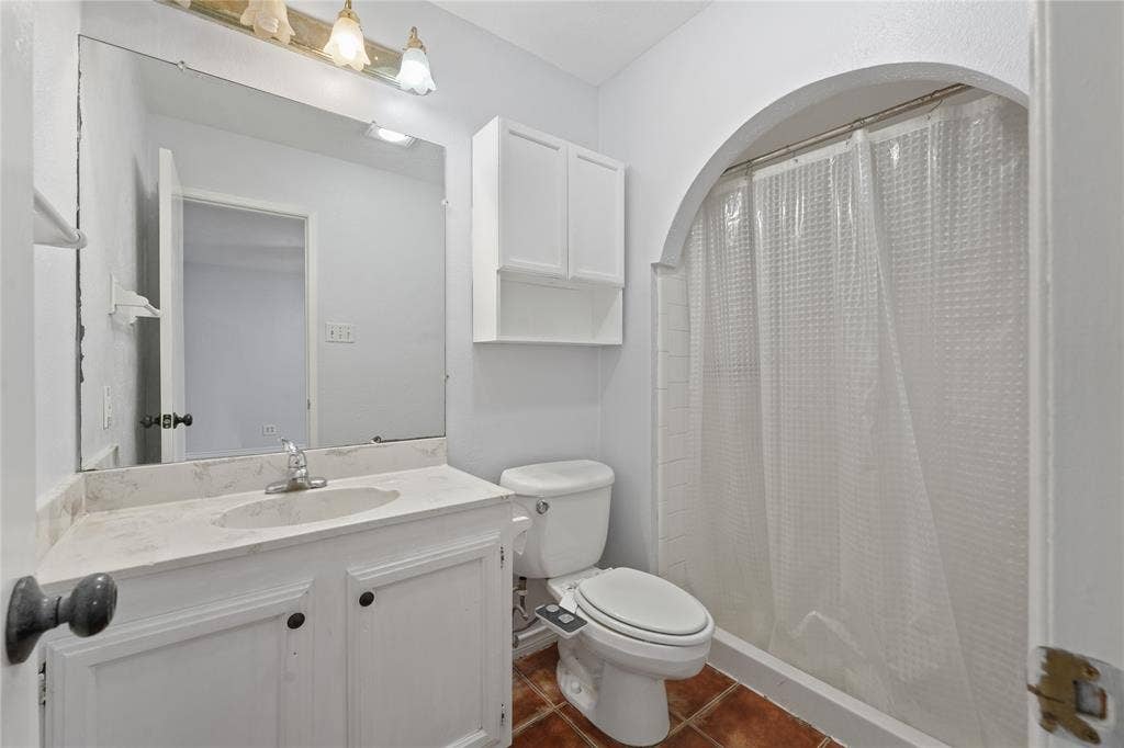 9214 Vagas Drive, Rowlett, TX 75088 Bathroom with toilet, tile flooring, and large vanity