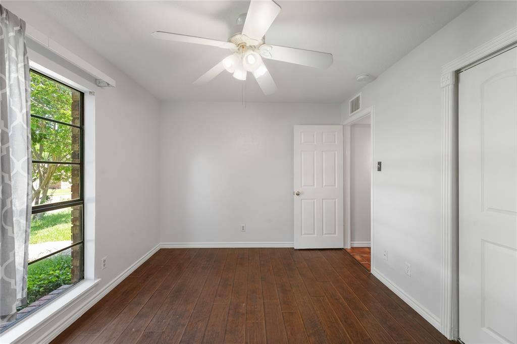 9214 Vagas Drive, Rowlett, TX 75088 Empty room featuring ceiling fan and dark hardwood / wood-style flooring