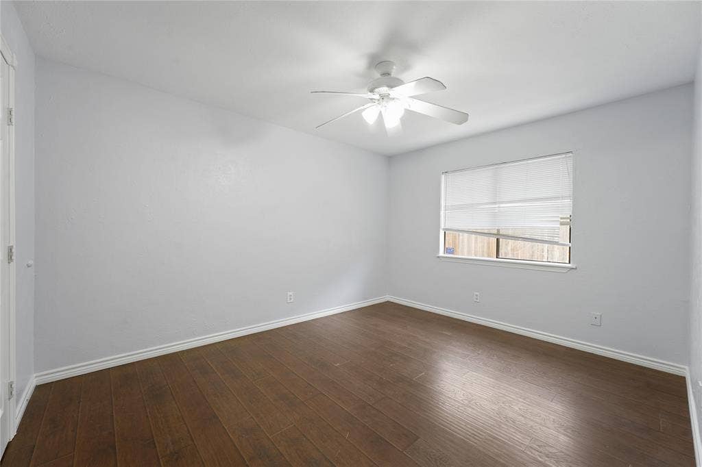 9214 Vagas Drive, Rowlett, TX 75088 Spare room featuring ceiling fan and dark hardwood / wood-style floors