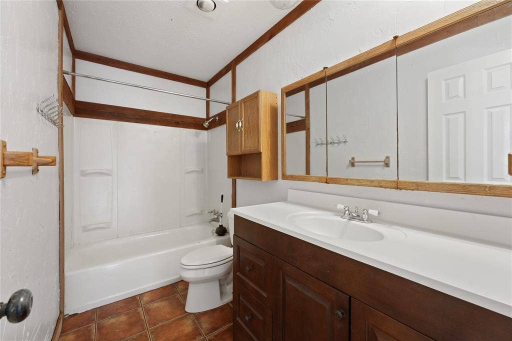 9214 Vagas Drive, Rowlett, TX 75088 Full bathroom with shower / washtub combination, tile floors, vanity, and toilet