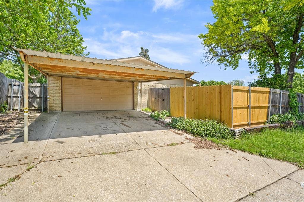 9214 Vagas Drive, Rowlett, TX 75088 View of front facade with a garage and a carport