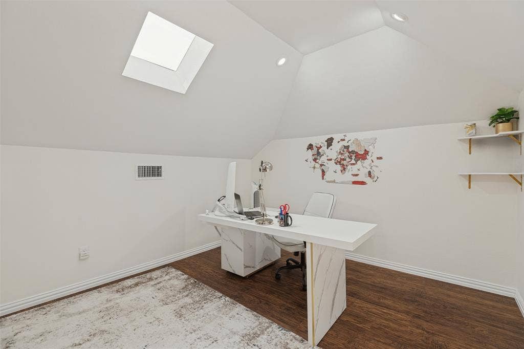 Vaulted ceilings featuring a skylight, recessed lighting, and wall-mounted shelving