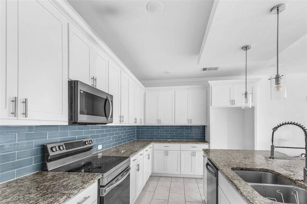 2002 Clay Street, Mabank, TX 75147 Kitchen with stainless appliances, granite-look counters, pull-down faucet and pendants